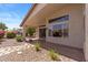 Inviting covered patio with tile flooring and views of the private backyard landscaping and flowering bushes at 10936 N Ventana W Dr, Peoria, AZ 85373