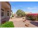 Lush backyard featuring a beautiful water feature, desert landscaping, and a covered patio for relaxing outdoors at 10936 N Ventana W Dr, Peoria, AZ 85373