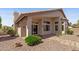 Charming covered patio with large windows overlooking the meticulously landscaped backyard with desert landscaping at 10936 N Ventana W Dr, Peoria, AZ 85373