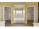Bathroom featuring a garden tub centered between walk-in closets illuminated by a glass block window at 10936 N Ventana W Dr, Peoria, AZ 85373