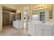 Well-lit bathroom with double sinks, a walk-in shower, and stylish mirrors, offering a spa-like experience at 10936 N Ventana W Dr, Peoria, AZ 85373