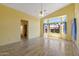 Bright bedroom includes an ensuite bath, wood-look floors, a ceiling fan, and bay windows with backyard views at 10936 N Ventana W Dr, Peoria, AZ 85373