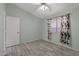 Bedroom illuminated by natural light features stylish curtains and wood-look flooring, creating a cozy space at 10936 N Ventana W Dr, Peoria, AZ 85373