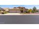 Charming single-story home featuring a spacious three-car garage and a well-maintained, landscaped front yard at 10936 N Ventana W Dr, Peoria, AZ 85373