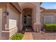 Inviting front entrance with tile walkway, desert landscaping, and a secure screen door at 10936 N Ventana W Dr, Peoria, AZ 85373