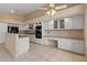 This bright kitchen features white cabinets, black appliances, tile flooring, and ample counter space at 10936 N Ventana W Dr, Peoria, AZ 85373