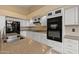 Open kitchen featuring white cabinets and stainless steel appliances with ample counter and cabinet space at 10936 N Ventana W Dr, Peoria, AZ 85373