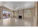 Inviting living room featuring a fireplace, tile floors, sliding glass doors to the patio, and natural light at 10936 N Ventana W Dr, Peoria, AZ 85373