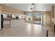 Open-concept living area with white cabinets, tile flooring, fireplace, and backyard access for entertaining at 10936 N Ventana W Dr, Peoria, AZ 85373