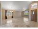Spacious living room with tile flooring, a chandelier, large windows, and a view of the front yard at 10936 N Ventana W Dr, Peoria, AZ 85373