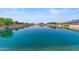 Picturesque waterfront neighborhood with calm waters reflecting the homes and clear blue sky above at 10936 N Ventana W Dr, Peoria, AZ 85373