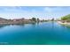 Beautiful view of a calm waterfront with charming homes and verdant trees adding to the scenic beauty at 10936 N Ventana W Dr, Peoria, AZ 85373