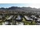 Scenic aerial of a desert community showcasing mature trees, landscaping and dramatic mountain views at 1120 E Beryl Ave, Phoenix, AZ 85020