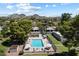 Aerial view of the pool in the community with lounge seating, mature trees, and a mountain view at 1120 E Beryl Ave, Phoenix, AZ 85020