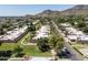 Scenic aerial of a desert community showcasing mature trees, landscaping, and views of the surrounding mountains at 1120 E Beryl Ave, Phoenix, AZ 85020