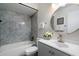 Bathroom featuring a vanity, mirror, toilet, and shower with stylish marble backsplash for a clean, modern design at 1120 E Beryl Ave, Phoenix, AZ 85020