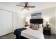 Bedroom with neutral decor, a ceiling fan, and ample closet space, offering comfort and functionality at 1120 E Beryl Ave, Phoenix, AZ 85020