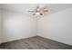 This is a cozy bedroom featuring gray wood-look flooring and a ceiling fan for comfortable living at 1120 E Beryl Ave, Phoenix, AZ 85020