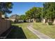 Well-manicured green space with manicured landscaping and meandering sidewalk to a desert community at 1120 E Beryl Ave, Phoenix, AZ 85020