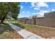 Exterior view of well-maintained home with lush greenery, trees, and a walking path at 1120 E Beryl Ave, Phoenix, AZ 85020