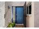 A vibrant blue front door with glass block sidelight and security door at 1120 E Beryl Ave, Phoenix, AZ 85020