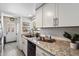 Kitchen featuring granite countertops, stainless steel appliances, a window, and a doorway at 1120 E Beryl Ave, Phoenix, AZ 85020
