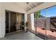Covered patio with ceiling fan and sliding glass doors, extending indoor-outdoor living space and natural light at 1120 E Beryl Ave, Phoenix, AZ 85020