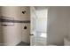 Tiled bathroom showcasing glass shelving and black plumbing fixtures at 121 E Monte Way, Phoenix, AZ 85042