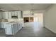Updated kitchen with gray cabinets, a stone countertop island, and open access to the adjacent living space at 121 E Monte Way, Phoenix, AZ 85042