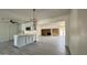Bright eat-in kitchen with gray cabinets, island, stainless steel microwave, and stone fireplace in the background at 121 E Monte Way, Phoenix, AZ 85042