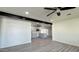 Open-concept living room featuring gray-toned flooring and flows seamlessly into the kitchen at 121 E Monte Way, Phoenix, AZ 85042