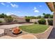 Well-maintained backyard featuring a green lawn, beautiful flowers, and desert landscaping at 1410 S Los Altos Dr, Chandler, AZ 85286
