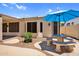 The backyard features a cozy patio area with a picnic table and a shade umbrella at 1410 S Los Altos Dr, Chandler, AZ 85286
