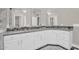 Well-lit bathroom with double vanity, stylish mirrors, and modern fixtures at 1410 S Los Altos Dr, Chandler, AZ 85286