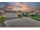 Beautiful single-Gathering home with a well manicured front yard and multi-car garage under a colorful sunset at 1410 S Los Altos Dr, Chandler, AZ 85286
