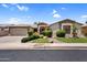 Beautiful single-story home featuring a well-manicured lawn, mature landscaping, and a three-car garage at 1410 S Los Altos Dr, Chandler, AZ 85286