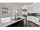 Modern kitchen with sleek white cabinets, black hardware, stainless steel appliances and a large island at 1410 S Los Altos Dr, Chandler, AZ 85286