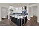 Modern kitchen island with bar seating, a wine cooler, and ample storage space at 1410 S Los Altos Dr, Chandler, AZ 85286