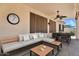 Covered patio includes comfortable seating, dining area, and ceiling fan, perfect for outdoor living at 1410 S Los Altos Dr, Chandler, AZ 85286
