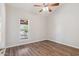 Comfortable bedroom featuring a ceiling fan, a window and wood-look flooring at 1452 E Gary St, Mesa, AZ 85203