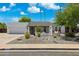 Charming single-story home featuring desert landscaping and a bright exterior under a clear blue sky at 1452 E Gary St, Mesa, AZ 85203