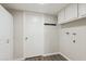 Functional laundry room features a storage cabinet and utility sink connections at 1452 E Gary St, Mesa, AZ 85203