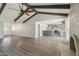 Open-concept living space with hardwood floors, exposed beams, and seamless flow to the kitchen at 1452 E Gary St, Mesa, AZ 85203