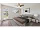 Staged main bedroom features wood-look flooring, ensuite access, and backyard access at 1452 E Gary St, Mesa, AZ 85203