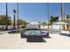 Relaxing pool area with cushioned outdoor seating and striped umbrellas at 1452 E Gary St, Mesa, AZ 85203