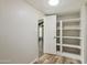 Large walk-in pantry features built-in shelving for optimal storage in the home at 1452 E Gary St, Mesa, AZ 85203