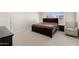 Comfortable bedroom features a large window, a relaxing chair, and a matching dark wood bed set at 1502 E Goldcrest St, Gilbert, AZ 85297
