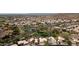 Expansive aerial view of a community with ponds and mountain views in a desert setting at 15235 S 30Th St, Phoenix, AZ 85048