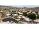 Expansive aerial view of desert community featuring tile-roofed homes, lush trees, and picturesque mountain views at 15235 S 30Th St, Phoenix, AZ 85048