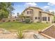 This landscaped backyard boasts a lush lawn, covered patio, and decorative brick edging, ideal for relaxation and outdoor living at 15235 S 30Th St, Phoenix, AZ 85048